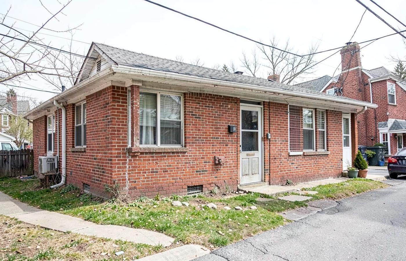 Small brick two-unit rental duplex on a residential corner lot